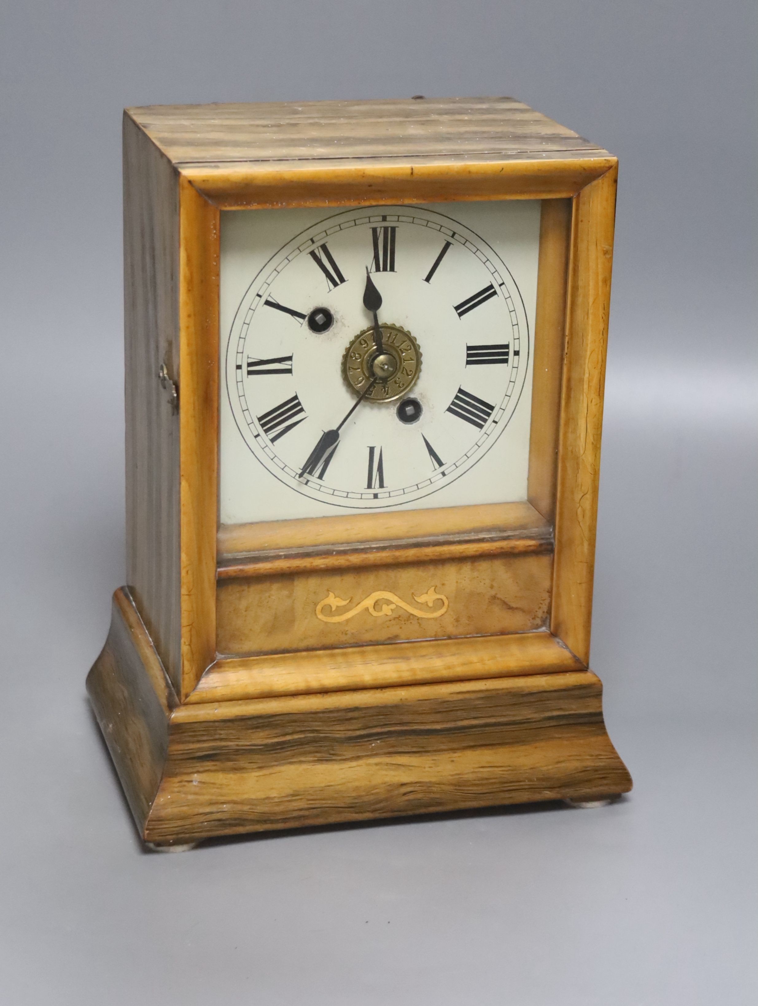 A 19th century walnut cased Black Forest mantel clock, bell striking movement with pendulum, height 24cm